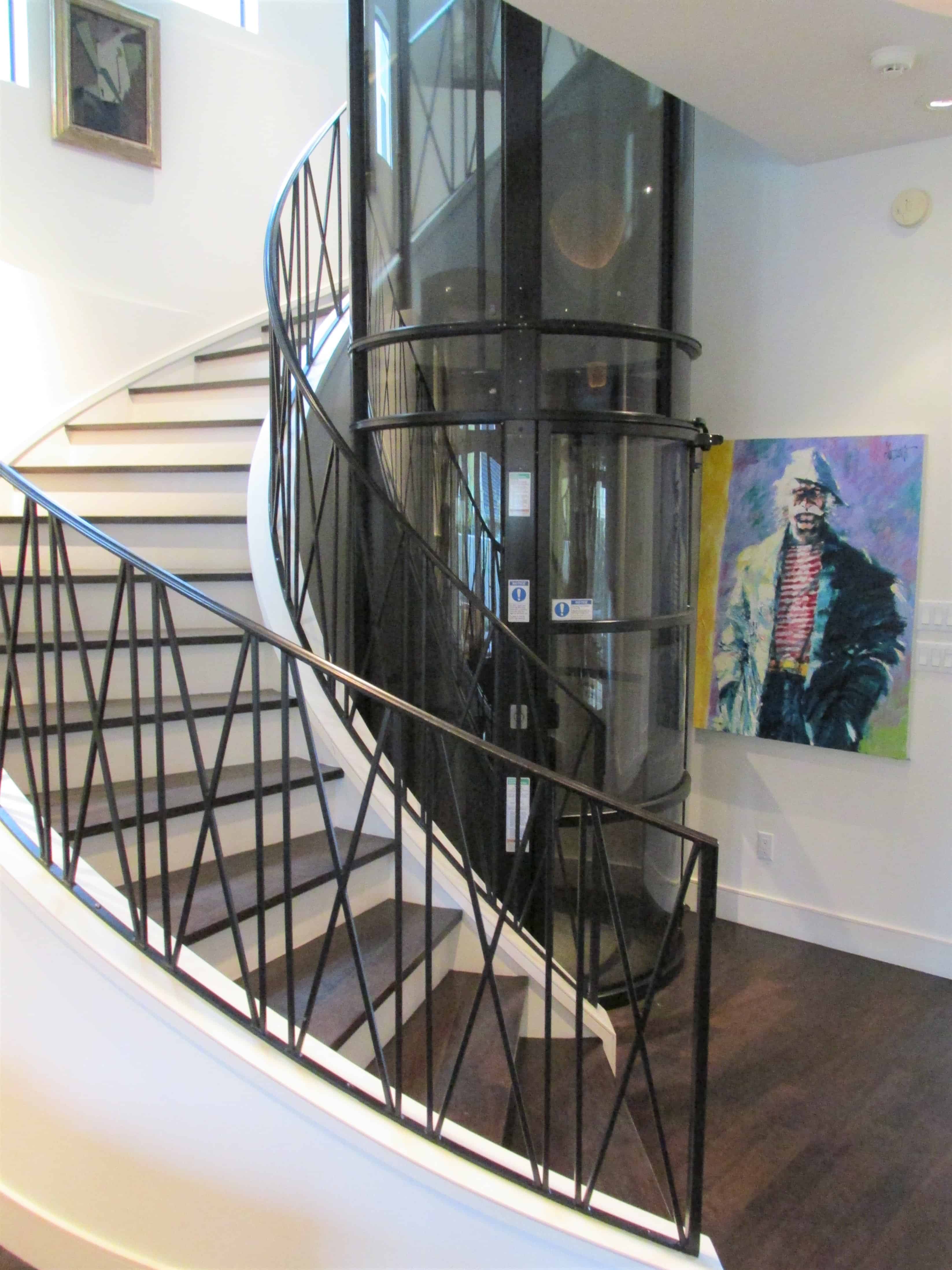lower floor of panoramic vacuum elevator installed in a circular stairwell in an upper kirby home in houston texas