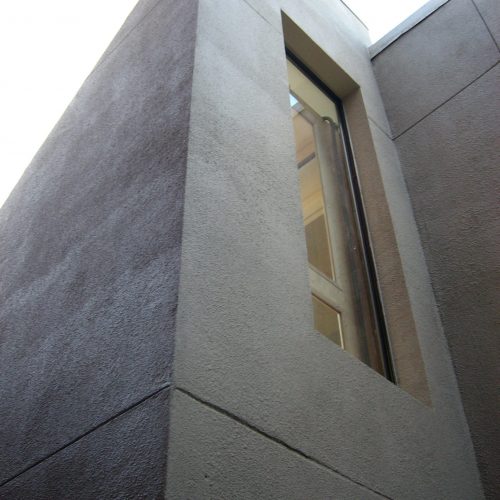 home elevator exterior shaft construction with stone stucco facade