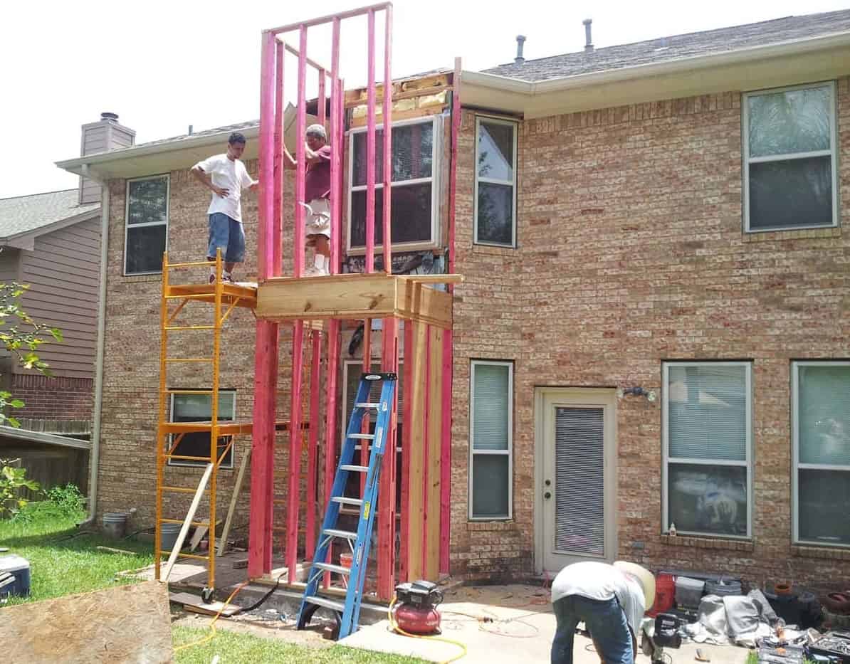 breakfast room bumpout of a 2-story brick home is extended to construct a home elevator shaft