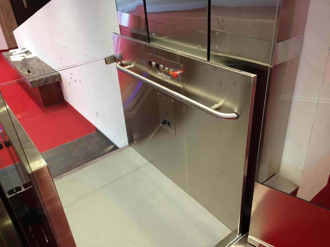 ada-compliant inclined platform lift in stainless steel finish with handrail