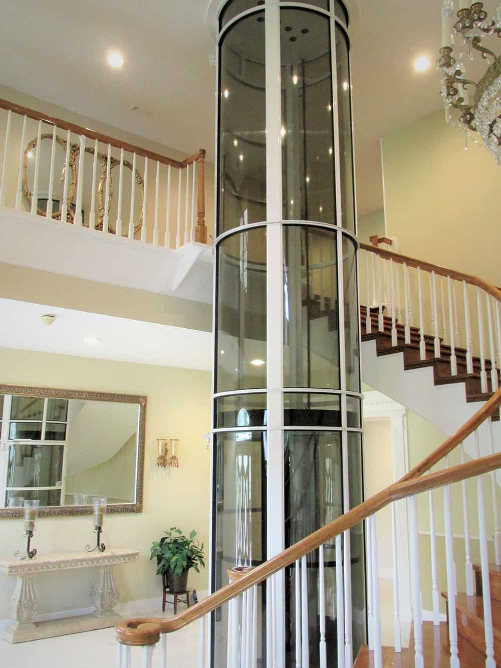 pneumatic vacuum elevator installed in the center of a winding staircase in a home in hitchcock texas just southwest of houston