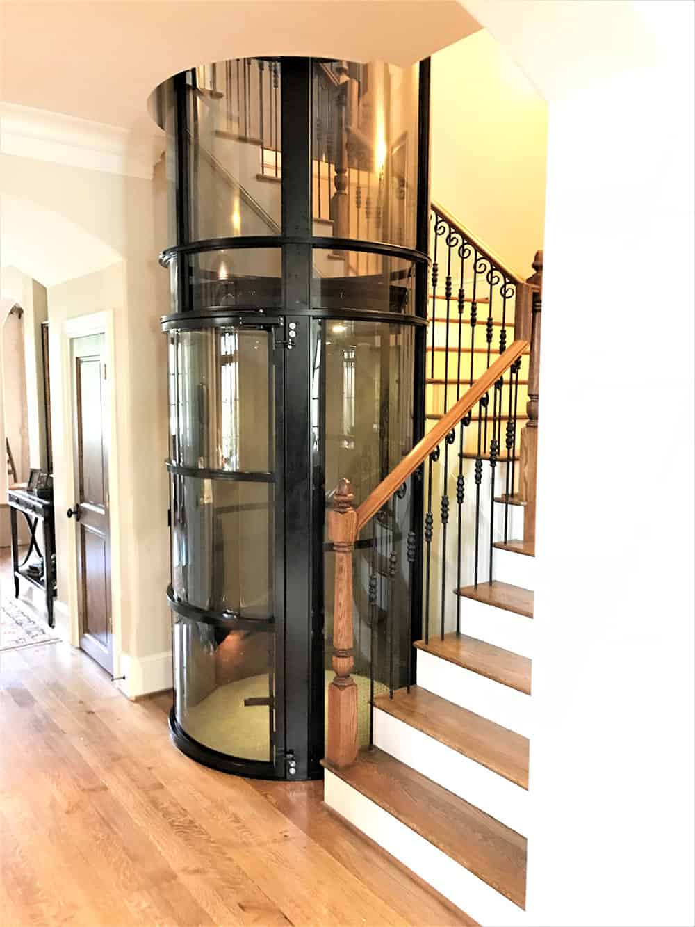 pve elevator installed in stairwell of winding staircase in a memorial area home in houston texas
