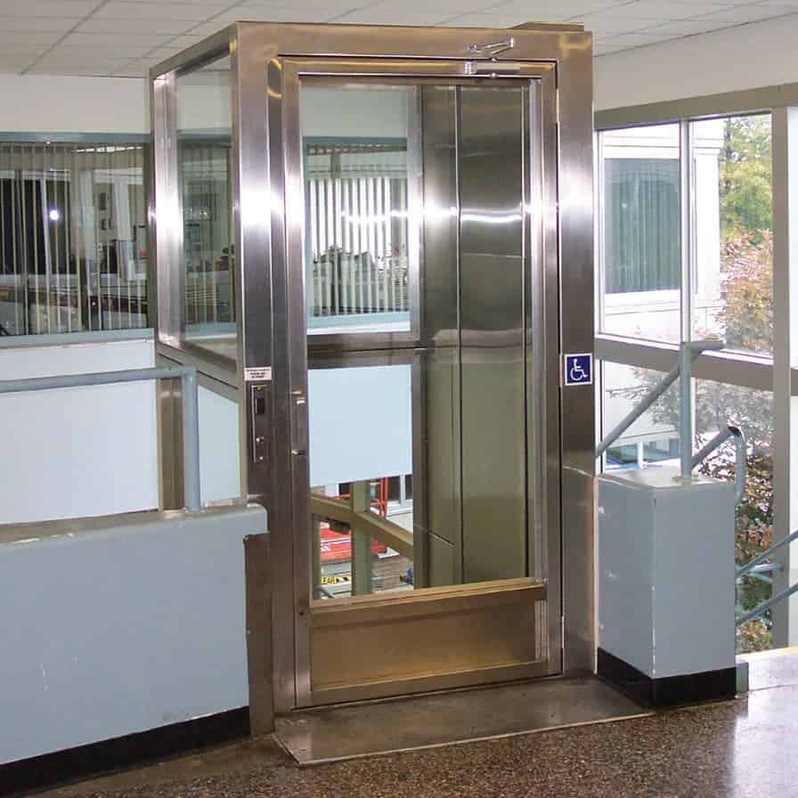commercial enclosed vertical platform lift with glass panel and stainless steel framed enclosure