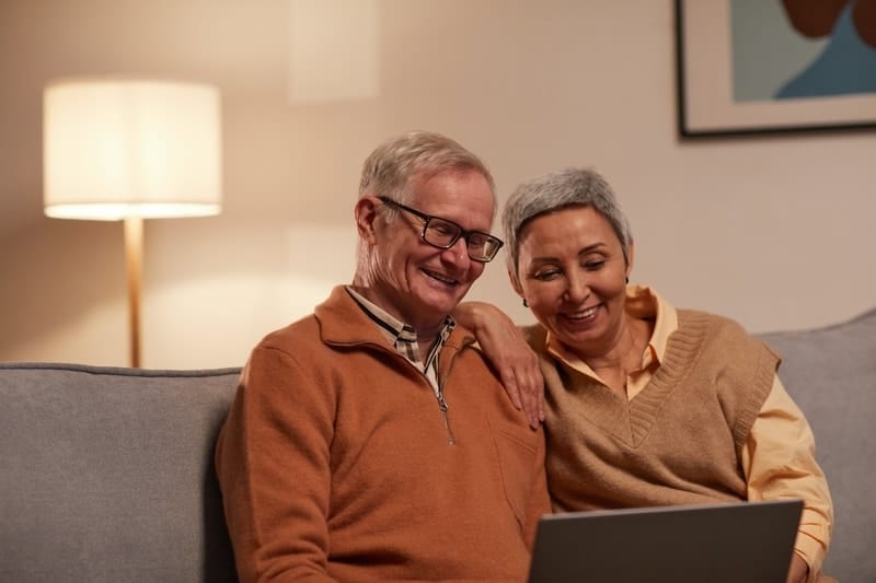 baby boomer couple researching aging in place or moving options