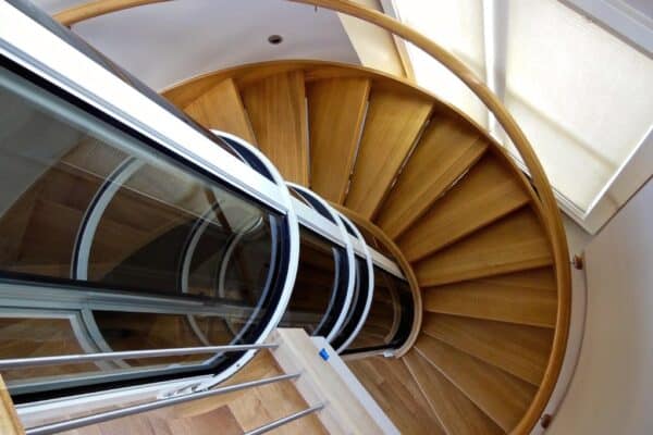 pve vacuum elevator installed in the center of a circular staircase