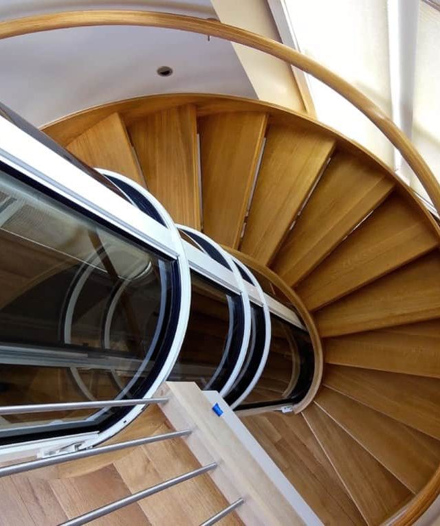 pve vacuum elevator installed in the center of a circular staircase
