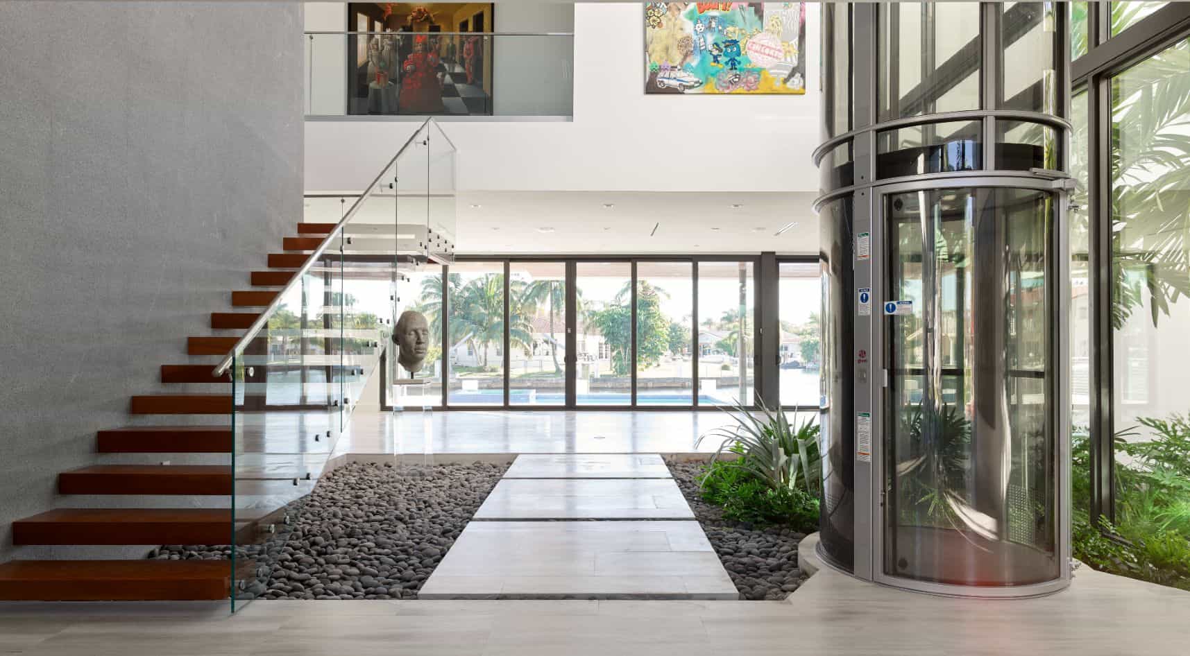 pve52 vacuum elevator in an anodized silver finish in a modern home's atrium entry way