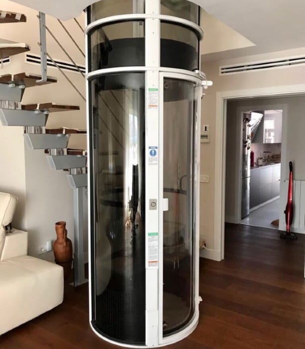 lower landing of a residential vacuum elevator with a white-finished frame